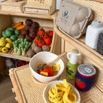 Set of toy vegetables and fruits on a wooden surface
