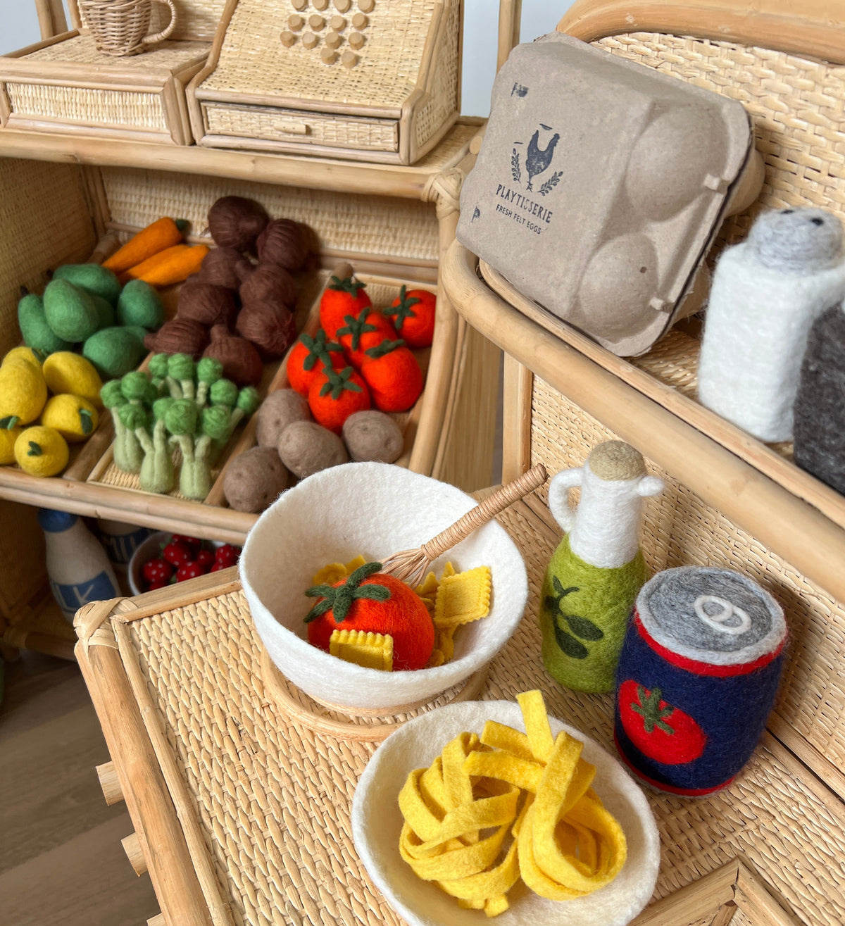 Set of toy vegetables and fruits on a wooden surface